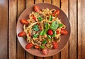 Home made vegan pasta with mushrooms, tomatoes and basil Royalty Free Stock Photo
