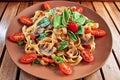 Home made vegan pasta with mushrooms, tomatoes, basil, peppers a Royalty Free Stock Photo