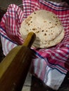 Home made wheat flour Indian roti or Indian bread with rolling pin in a basket. Uttarakhand India Royalty Free Stock Photo