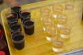 Home made wine tasting on a street market, organic ecological wine by local producers. Wine in small plastic glasses Royalty Free Stock Photo