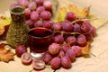 Home made wines wicker bottle and grapes Royalty Free Stock Photo