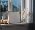 Home mockup, frame close up standing on windowsill at winter evening time