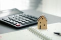 home model on notebook with pen and calculator Royalty Free Stock Photo