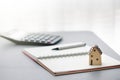 home model on notebook with pen and calculator Royalty Free Stock Photo