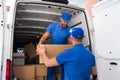 Home Moving Services. Movers Loading Van Royalty Free Stock Photo
