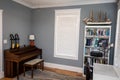 Home music room for students with a wood piano and blue gray walls Royalty Free Stock Photo