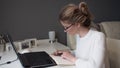 Home office, business girl with glasses working on a laptop. Royalty Free Stock Photo