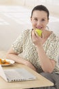 Home office business woman eating an apple Royalty Free Stock Photo