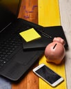 Home office composition. Piggy bank in pink color with gadgets