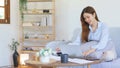 Home office concept, Businesswoman reads marketing plan data on laptop and taking notes on notebook