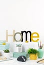 Home office concept with flowers in the pots, office supply, computer keyboard and mouse Royalty Free Stock Photo