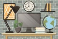 Home office concept, workspace. Computer monitor, table lamp, globe, indoor plants, books and wall posters. Background Royalty Free Stock Photo