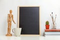 Home or office decor with mock up blank chalkboard on table near white wall Royalty Free Stock Photo