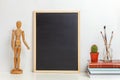 Home or office decor with mock up blank chalkboard on table near white wall Royalty Free Stock Photo