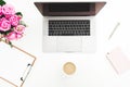 Home office desk with female workspace with laptop, pink roses bouquet, accessories, coffee mug, pink diary on white background. F Royalty Free Stock Photo