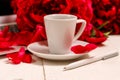 Home office desk with laptop, pink peonies, mug of coffee, stationery, glasses on a white background