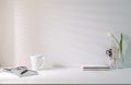 Home office desk with stationery, coffee cup,glasses and flower pot. Copy space for your text