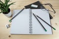 Home office desk for work, study and school with a blank spiral notebook and stationary supplies on a wooden table, copy space Royalty Free Stock Photo