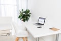 home office with laptop with facebook logo, smartphone and notebook