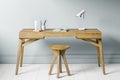 Home office or study, close up view of wooden chair and table with gray blue wall in background and light wood floor Royalty Free Stock Photo