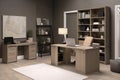 a home office suite with a desk, chair, filing cabinet and bookshelf