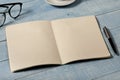 Home office table with open notebook with blank pages Royalty Free Stock Photo