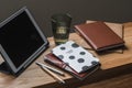 Home office. A tablet, a planner, a diary, notebook and a glass of water on a wooden table in the living room Royalty Free Stock Photo