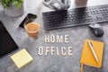 Home office text desk with keyboard computer smartphone notebook houseplants, working space at home