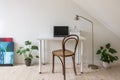 Home office. Vintage chair at white desk with laptop computer. Royalty Free Stock Photo