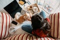 Home office, work space, work from home concept. Young woman with laptop and cat working at sofa. Flexible work hours Royalty Free Stock Photo