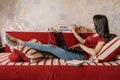 Home office, work space, work from home concept. Young woman with laptop and cat working at sofa. Flexible work hours Royalty Free Stock Photo