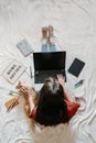 Home office, work space, work from home concept. Young woman with laptop and cat working at sofa. Flexible work hours Royalty Free Stock Photo