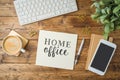 Home office and working from home concept. Table workplace with keyboard computer, notepad and coffee cup. Top view from above Royalty Free Stock Photo