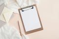 Home office workspace with blank clipboard, pen, blanket and envelope on beige table. Flat lay, top view Royalty Free Stock Photo