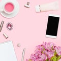 Home office workspace with copyspace. Top view Beauty blog concept. Woman fashion accessories, phone on pink background. Royalty Free Stock Photo