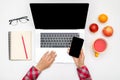 Home office workspace mockup. Laptop with blank screen, hands and accessories on white Royalty Free Stock Photo