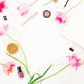 Home office workspace with notebook, cosmetics, pink tulips and accessories on white background. Round frame. Flat lay, top view.