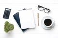 Home office workspace. Tablet, glasses, notepad, cup of coffee, pen, succulent on white wooden background. Top view Business,