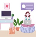 Home office workspace, woman on cushion using laptop in the room with cat computer and plants