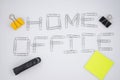 `Home office` written with metal paper clips on the white paper background. Flat lay. Stay home. Remote work. Remote education. Qu