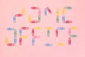`Home office` written with multicolored paper clips on the pink paper background