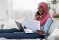 Home Office. Young Black Muslim Freelancer Woman Working With Papers And Laptop Royalty Free Stock Photo