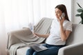 Home Office. Pregnant Lady Working With Papers And Laptop In Living Room Royalty Free Stock Photo