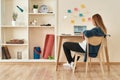 Home office. Young woman in casual clothes sitting at office desk, working or studying working or studying on laptop at Royalty Free Stock Photo