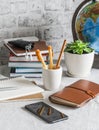 Home online school education. Stack of books , notebooks, pens, pencils, Notepad, phone, globe on the table in a bright room Royalty Free Stock Photo