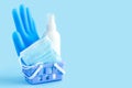 Home ordering, personal protective equipment in quarantine. gloves, mask, sanitizer in basket on blue background Royalty Free Stock Photo