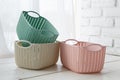 Home organizers colored baskets on white table