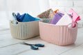 Home organizers colored baskets on white table