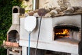 Home outdoor stone pizza oven with two pizza shovels Royalty Free Stock Photo