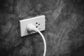 Home outlet plug is plugging socket on wall with white power cord cable - Power plug connecting electrical plug Royalty Free Stock Photo